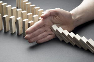 businessman-hand-stop-domino-continuous-tipping-risk-strategy-business_8119-812